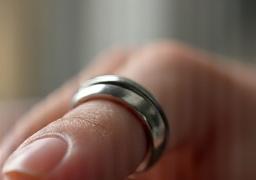 Oura Ring on a finger, showing its sleek design.